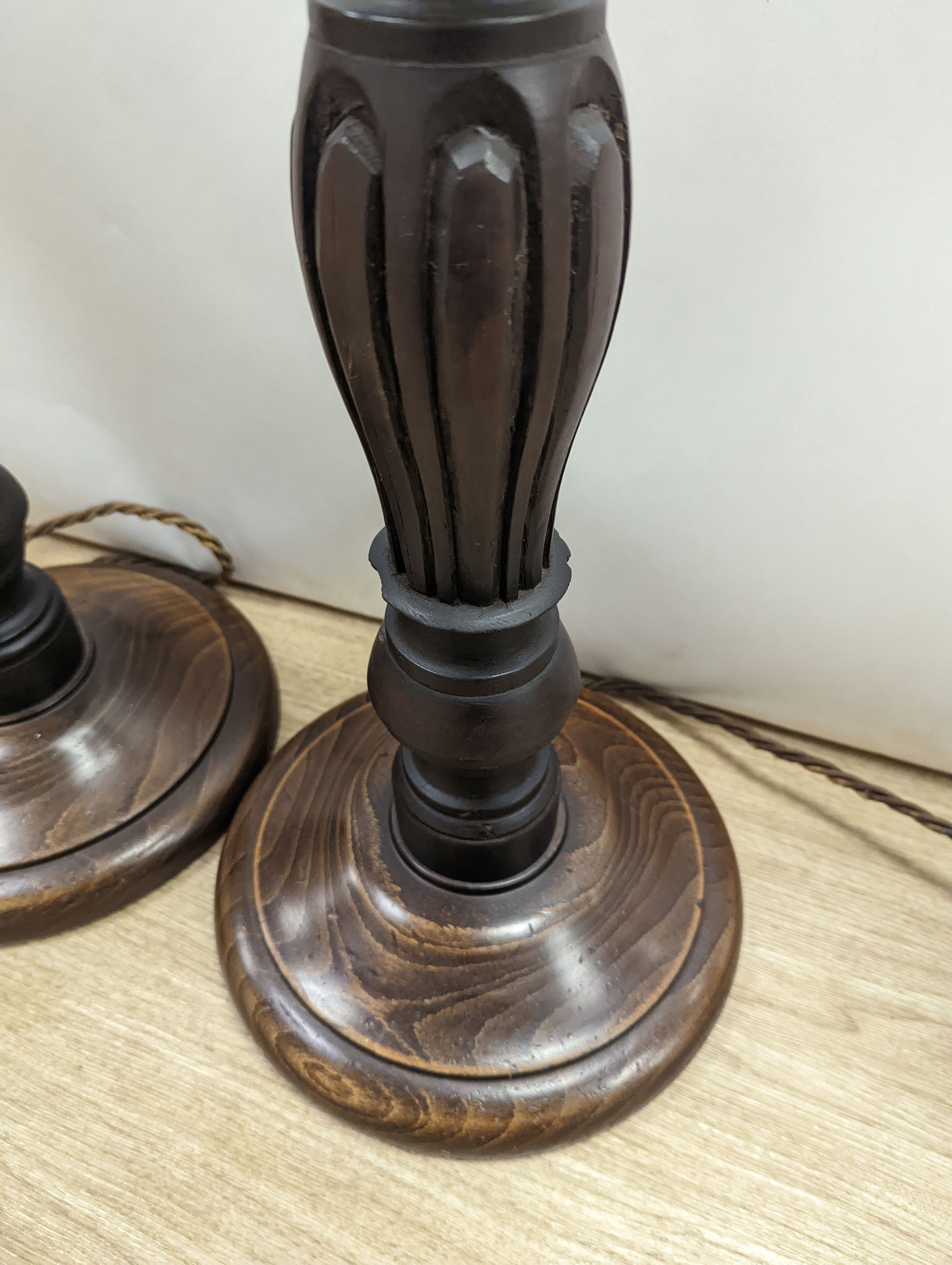 A pair of turned wood lamp bases, height 69cm excl. fitting